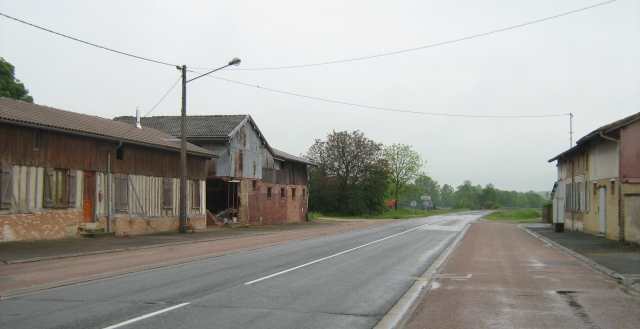 a wide street with ramshackle buildings in france